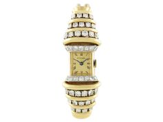 A dazzling design from Van Cleef & Arpels, this Retro diamond watch is a fabulous piece of history. A double yellow gold snake band culminates in a stepped diamond and high polish gold top with a central golden face. The fine clasp features a quintet of star set diamonds. Dial and clasp signed Van Cleef & Arpels. Gold Art Deco Diamond Watch, Luxury Antique Diamond Watch, Luxury Antique Gold Diamond Watch, Luxury Vintage Yellow Gold Watch, Luxury Gold Diamond-accented Watch, Van Cleef Arpels Diamond, Retro Van, Bracelet Watches Women, Van Cleef And Arpels Jewelry