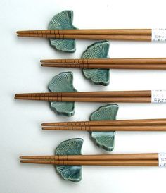 four chopsticks with green leaves on them