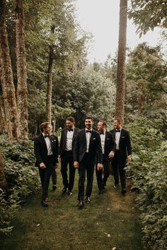 a group of men in tuxedos standing next to each other