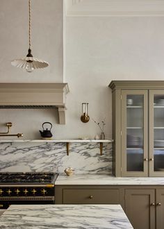 a kitchen with marble counter tops and cupboards in the center, along with an oven