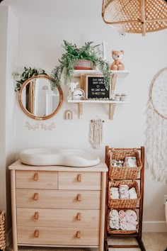 a baby's room with white walls and wooden furniture