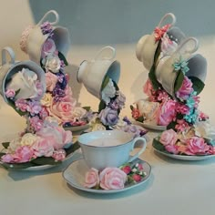 tea cups and saucers with flowers on them