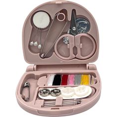 an open pink case with scissors, thread and other items in it on a white background