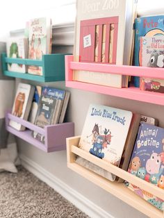 children's books are lined up on shelves in a room with carpeted flooring