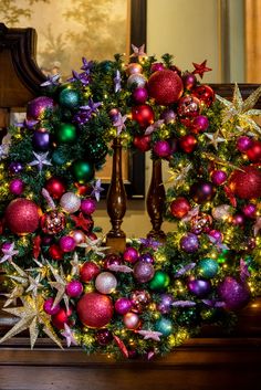 a decorated christmas wreath on top of a mantle