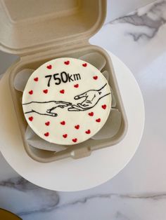 a cake in a box with the words 750 km printed on it