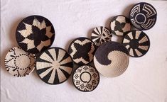 black and white woven baskets are arranged on a white tablecloth, with circles in the middle