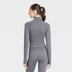 Why we're ALL IN: Seamless half-zip pullover jacket in a solid hue. Designed with a mock turtleneck and flat seams. Made from a nylon and spandex blend with moisture-wicking properties for a cool and fresh feel. The fitted silhouette and cropped length with a plain hem complete the flattering look. All in Motion™: Inspiring the potential in every body. Versatile Solid Color Half-zip Tops, Half-zip Sports Top For Fall, Half-zip Sport Tops For Fall, Fall Sports Half-zip Top, Versatile Half-zip Sports Top, Versatile Half-zip Gym Tops, Versatile Half-zip Tops For The Gym, Versatile Solid Half-zip Activewear, Versatile Half-zip Solid Activewear