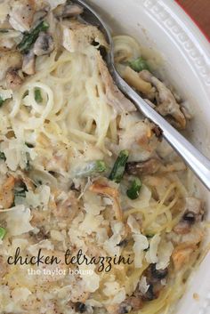 a white bowl filled with pasta and chicken