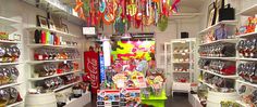 a store filled with lots of different types of candy and candies hanging from the ceiling