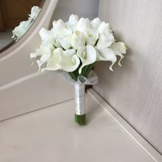 a bouquet of white flowers sitting on top of a counter