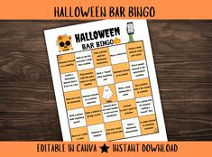 the halloween bar bingo game is displayed on a wooden table with an orange and white background