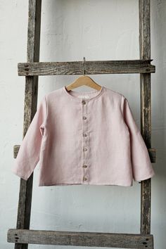 Long sleeve classic shirt with coconut buttons is made of 100% soft medium weight linen. The shirt is suitable for both girls and boys.  Details: - Choose size and embroidery in the drop down menu - Colour: Baby pink - Composition: 100% Oeko-Tex certified linen - Coconut buttons down the front - Medium weight linen - Unisex  - Relaxed silhouette - Linen care: machine wash gentle; tumble dry low, ironing optional - The price is for one shirt, other pictured items are not included Boys Linen Shirt, Shirt Linen, Pink Long Sleeve, Tee Dress, Etsy Fashion, Classic Shirt, Linen Shirt, Medium Weight, Kids Dress