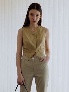 Editor's NotesThis vest from OSTKAKA is crafted from linen blend that has a v-neckline and front button fastenings with an asymmetric hemline. It is a sophisticated and elegant refinement that can be worn as its own or as a layering piece over a tee. - Linen blend vest- Front button closures, v-neckline, front welt pockets, asymmetric hemlineMeasurements (in.)S / M- Length: 14.56 in. / 14.96 in.- Chest: 18.11 in. / 19.09 in.- Shoulder: 13 in. / 13.38 in.- Hem: 14.96 in. / 15.94 in.- Armhole Linen Vest For Daywear, Beige Linen Spring Vest, Spring Workwear Linen Vest, Beige V-neck Vest For Work, V-neck Linen Vest For Workwear, Beige V-neck Vest With Buttons, Classic Beige V-neck Vest, Tailored Linen Vest For Summer, Chic Linen Vest