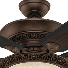 a close up view of a ceiling fan with an ornate design on the blades and light fixture