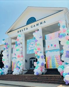 the front entrance to delta garmaa is decorated with balloons and pastel colors