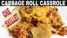 a white plate topped with lasagna covered in cheese and meat next to a sign that says cabbage roll casserole