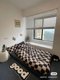 a bed room with a neatly made bed next to a window and rugs on the floor