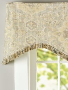 an open window with a curtain and valance