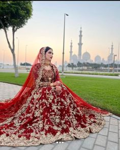 a woman in a red and gold wedding dress