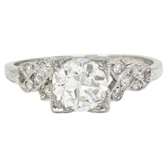 an antique style diamond ring with three stone accents