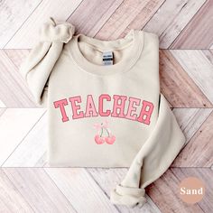 This cozy sweatshirt is perfect for the soft girl teacher in your life! She will love the whimsical elegance of this comfy crewneck. SIZING & SWEATSHIRT INFO: Premium Unisex Gildan 18000 Sweatshirt that are light weight and we use DTG Printing method that lasts 50+ washes! Since these are unisex sizing, women usually like their normal women's size for a more relaxed fit or size up one to two sizes for a more oversized look. If you are not sure what unisex adult shirt size to get, lay a sweatshir Cute Text Print Sweatshirt For Fall, Cute Crew Neck Sweatshirt For School, Cute Relaxed Fit Sweatshirt With Letter Print, Cute Cotton Sweatshirt For School, Cute Long Sleeve College T-shirt, Trendy Letter Embroidery Sweatshirt For Loungewear, Cute Sweater With Letter Print And Relaxed Fit, Cute Relaxed Fit Sweater With Letter Print, Spring School Spirit Sweatshirt With Letter Print