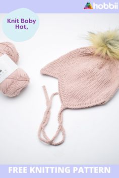 two balls of yarn and a knitted baby hat