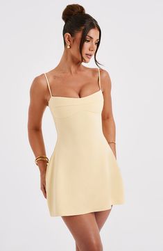 Keep it fun and flirty in the Dakota dress, everyone's fave mini of the season. Made in our lightweight stretch crepe, this figure-hugging design snatches in at the waist and flares into an A-line skirt. The neckline has a slight sweetheart shape with seam detail, while the straps are adjustable for your perfect fit.Â     Colour: Lemon.  Premium stretch crepe fabric.  Fully lined.  Slight sweetheart neckline.  Seam detail on bust.  Shaped underbust.  A-line shape skirt.  Adjustable straps.  Invi Homecoming Dresses Corset, Midi Dress Wedding Guest, Maxi Dress Sale, Lemon Dress, Sparkle Dress, Mini Dresses For Women, Stretch Crepe, Dresses By Length, Formal Dresses Prom