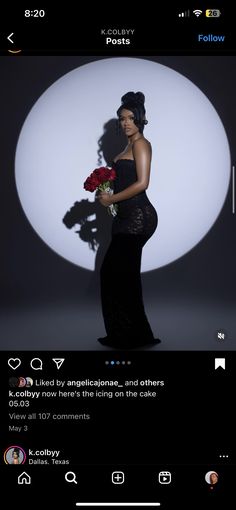 a woman in a black dress holding flowers and posing for an instagramtion photo