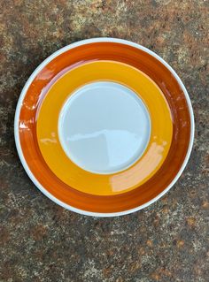 an orange and white plate sitting on top of a counter