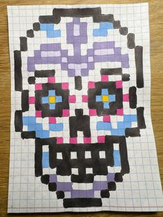 a piece of paper that has been made to look like a skull with colorful squares on it