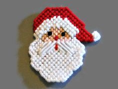 a cross stitch christmas ornament with a santa clause on it's face