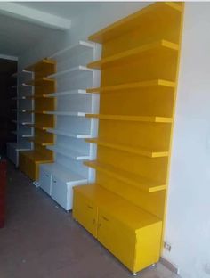 yellow and white bookshelves in an empty room