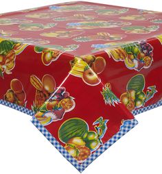 a red tablecloth with fruit and vegetables on it, sitting on top of a checkered table cloth