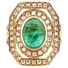 Introducing the epitome of luxury and sophistication, behold the breathtaking Victorian inspired, Emerald Statement Ring, a true marvel in the world of fine jewelry. Crafted with precision and passion, this extravagant piece exudes opulence from every angle, making it a coveted treasure for discerning connoisseurs. At the center of this masterpiece lies a resplendent 2.70 Carat Cabochon Zambian Emerald gemstone. The emerald, known for its unparalleled elegance and rarity, boasts a green color th Emerald Statement Ring, Silver And Gold Rings, Victorian Diamond Ring, Rosecut Diamond Ring, Swirl Ring, Gold Statement Ring, Gold Cocktail Ring, Zambian Emerald, 18k Gold Ring