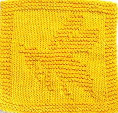 a yellow knitted square with the word love written on it