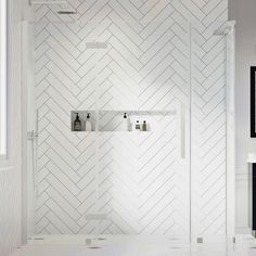 a white bathroom with herringbone tile on the shower wall and shelves in the corner