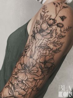 a woman's arm with flowers on it