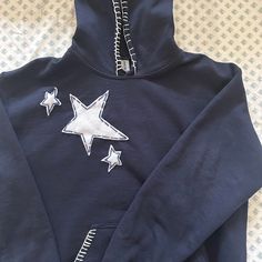 a blue hoodie with white stars on it