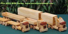 a wooden toy truck and trailer with trees in the background