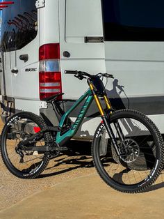 a mountain bike parked next to a van