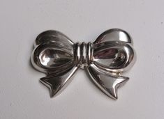 "The past will always return in the fashion world and this piece is back for round two! In the 1920's ladies of class wore the most opulent dresses with jewelry to match. As the years continued, jewelry makers tailored pieces to fashion and trends which resulted in affordability for style. Presenting this Beautiful Vintage Sterling Silver Puffy Ribbon Bow Designer Brooch Pin Featuring Classical Whimsical Designs. Approximate Size: 1 7/8\" High by 2 5/8\" Wide. Don't forget to LIKE ☑️ us on Faceb Designer Brooch, Round Two, Promotional Events, Bow Earrings, Fashion World, Ribbon Bow, Jewelry Maker, Ribbon Bows, Vintage Sterling Silver