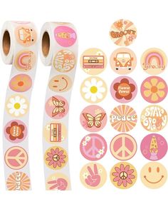 two rolls of pink and yellow stickers next to each other with peace symbols on them