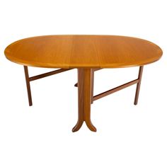 an oval wooden table with two leaves on the top and one leaf at the base