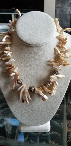 Natural Beachy Shell Necklace with Carved Soapstone, Matching Earrings Sterling Silver Ear Wires.   Great necklace for a beach vacation or just for summer!  Large slivers of natural shell with clear quartz round beads and carved soapstone round beads.    Pretty heart clasp, 19 inches long.  Cool and classy!   Matching earrings with topaz Swarovski bicone crystals and sterling silver ear wires included! Go ahead, be different!  This piece is unique and, as usual, one of a kind!   Sure to garner the wearer many compliments! Handmade Mother Of Pearl Jewelry For Anniversary, Unique Pearl Jewelry For Anniversary, Handmade Mother Of Pearl Necklace For Anniversary, Handmade Pearl Jewelry For Anniversary, Unique Mother Of Pearl Jewelry For Wedding, Bohemian Wire Wrapped Jewelry For Anniversary, Artisan Handmade Pearl Jewelry, Artisan Wire Wrapped Jewelry For Wedding, Handmade Artisan Pearl Jewelry