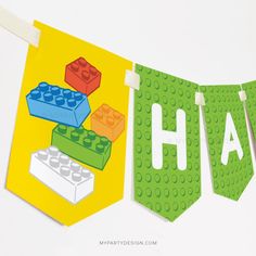 a banner with legos and blocks hanging from it's clothesline that says aha