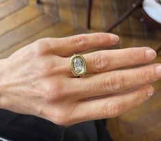 a person's hand with a ring on it