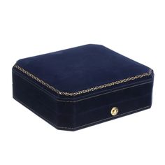 a blue velvet jewelry box with gold chain trimmings on the lid and sides