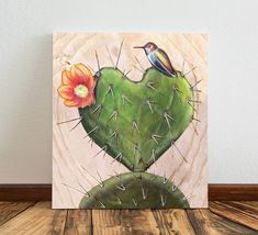 a painting of a bird sitting on top of a cactus