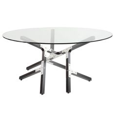 a round glass table with metal legs